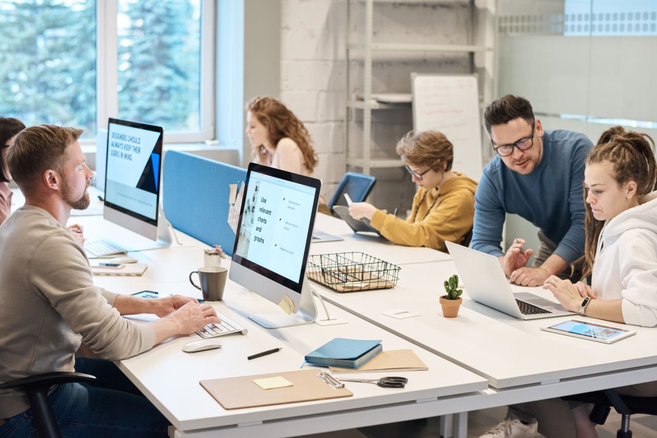 Support team working at desktop computers in an open-plan office