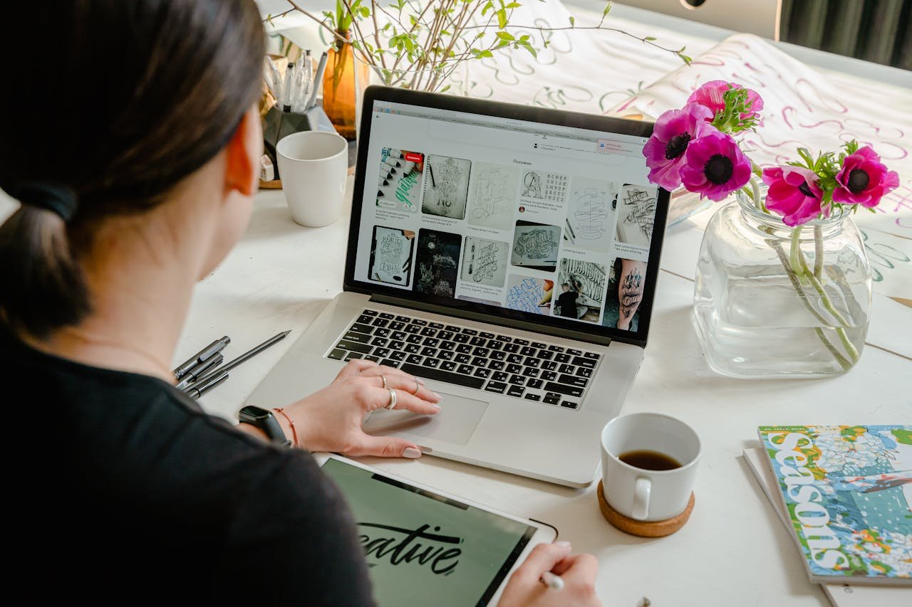 Person using a laptop to edit a website layout with color and font options visible