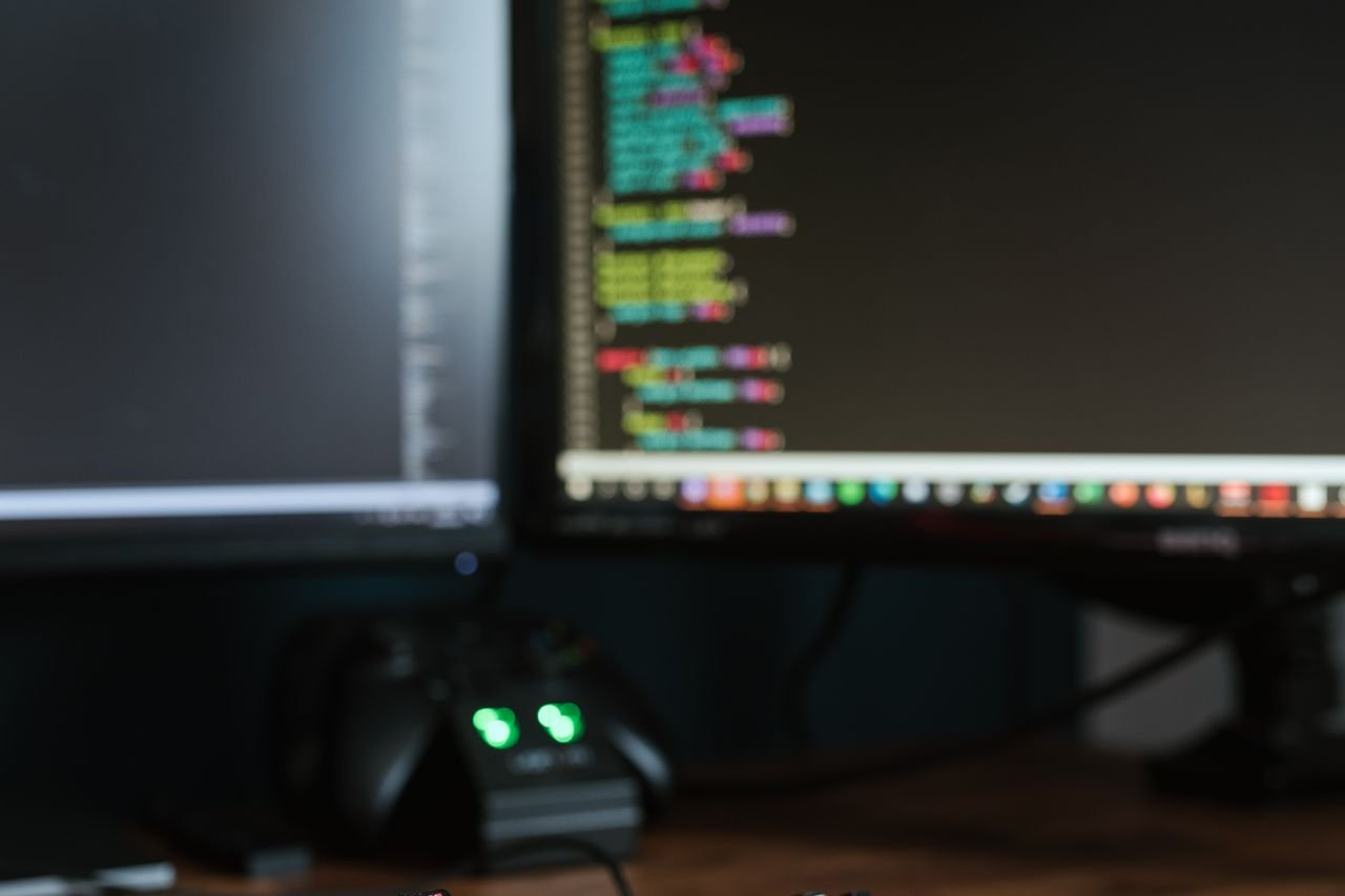 Colorful code displayed on a monitor in a dim workspace