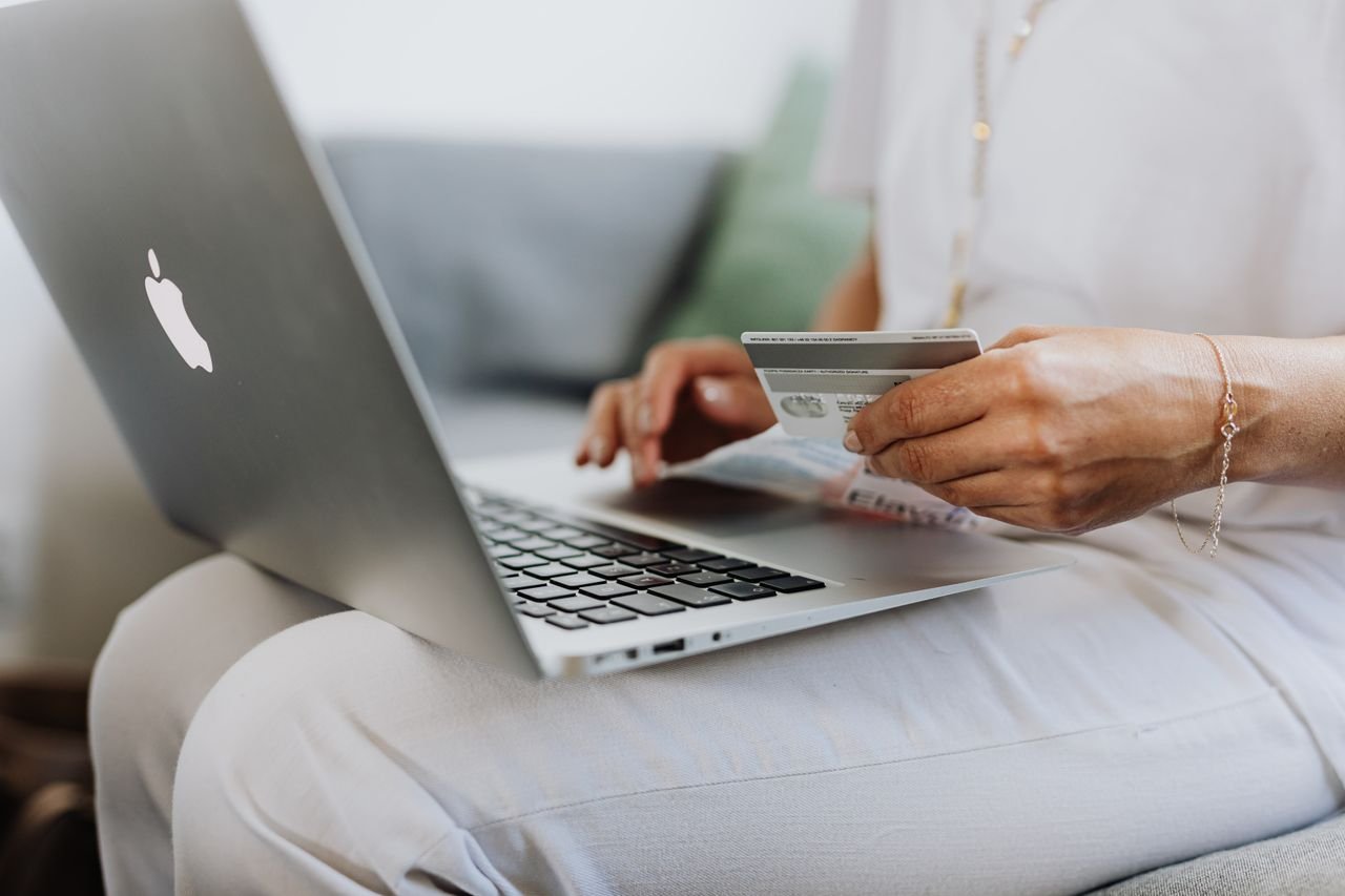 Person entering payment details on a laptop during online checkout